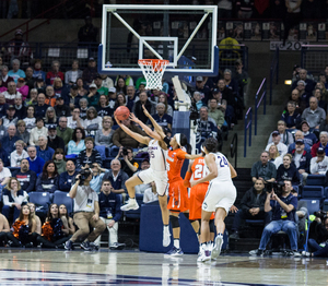 A Connecticut player attempts a reverse layup on Monday night against the Orange. The four-time defending champs Huskies beat SU by 30.